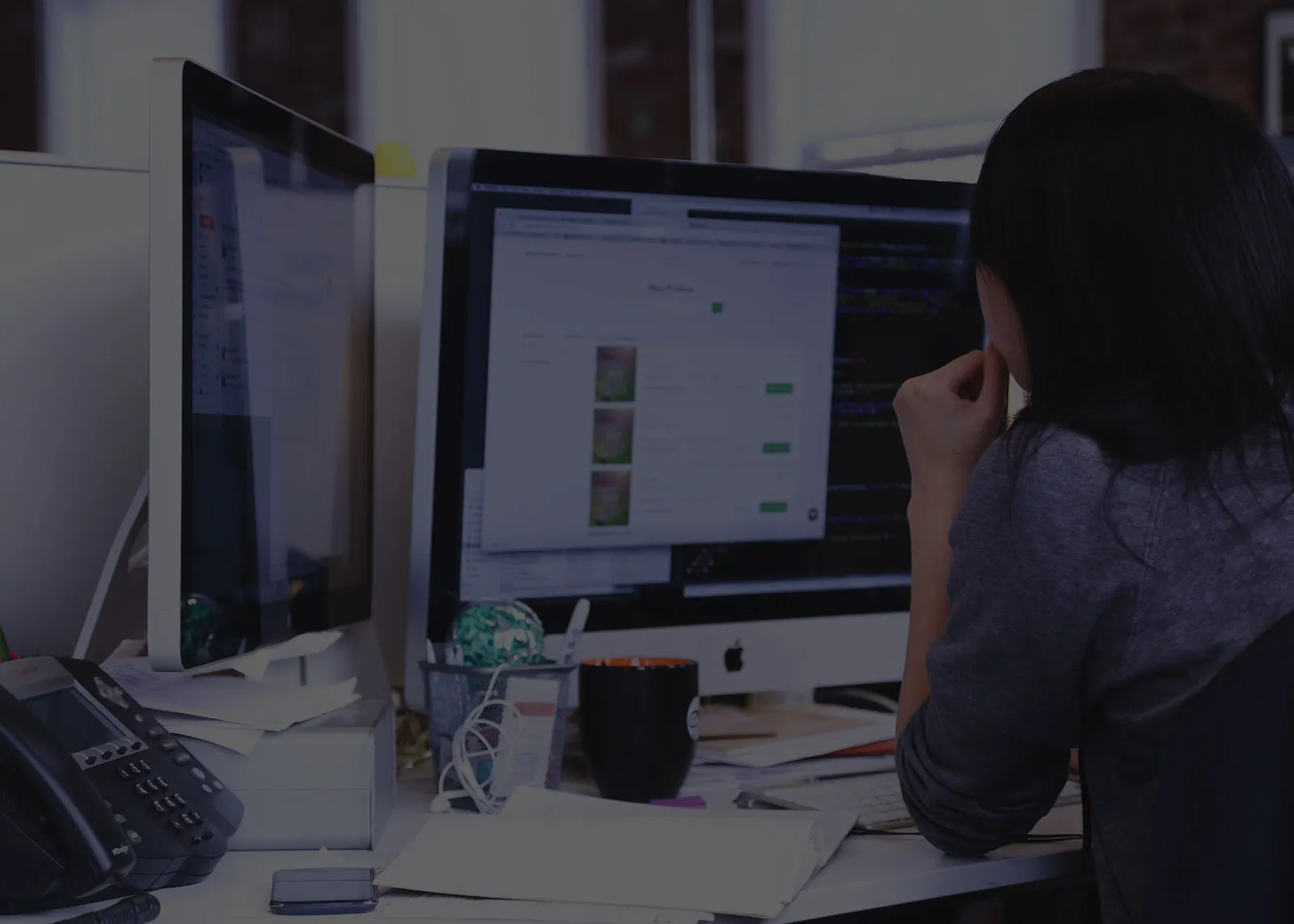 A trader reviewing charts across several monitors